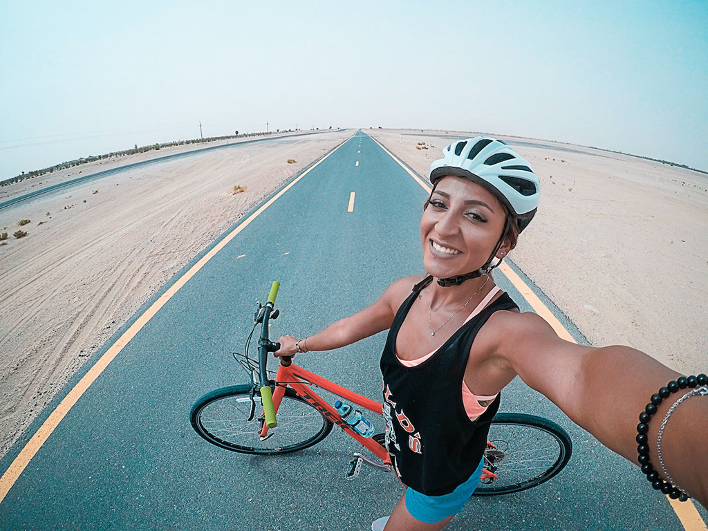 female on bike taking a selfie